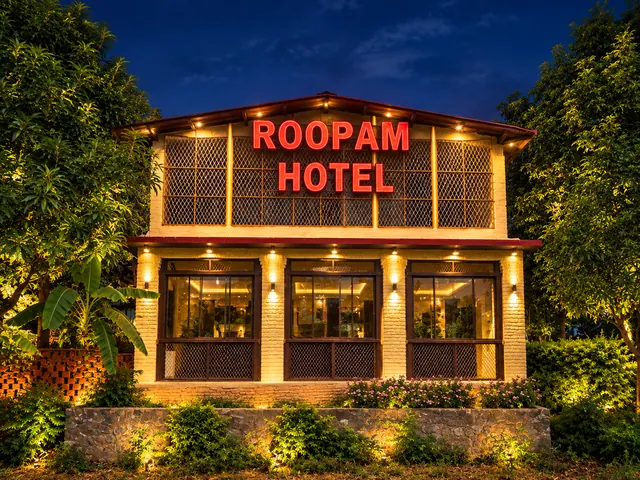 Roopam Resort entrance building glowing with warm evening lights against a deep blue sky in Ranakpur